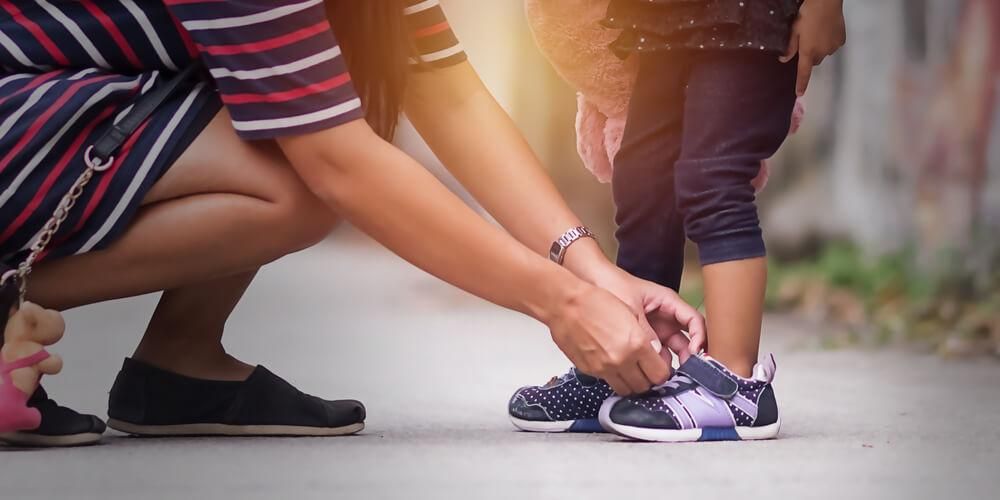 Girl and her shoes. Girl wearing Shoes of mother.